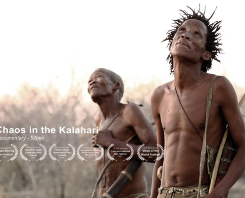 Deux personnes regardent vers le haut dans un décor naturel, sous le titre du film « Chaos in the Kalahari », orné de symboles de récompenses en dessous. Découvrez-en plus sur ce film captivant sur katethompsongorry.com. Limbus Studio