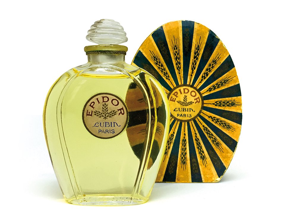 Flacon de parfum Epidor vintage avec emballage jaune et noir assorti, étiqueté « Lubin Paris ». Le design élégant rappelle le graphisme classique, capturant l'essence d'un art intemporel, à l'image d'un site WordPress bien conçu. Limbus Studio